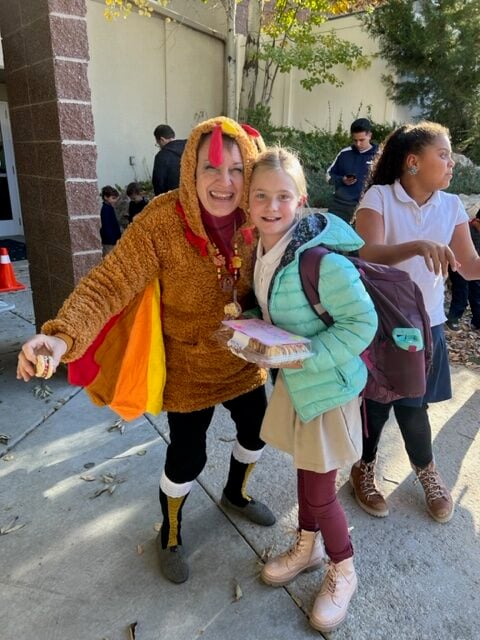 teacher in turkey costume with student
